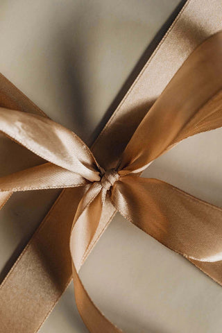 Gold ribbon bow on gift box - anAltesse Studio  hairbrush  to give or personalize