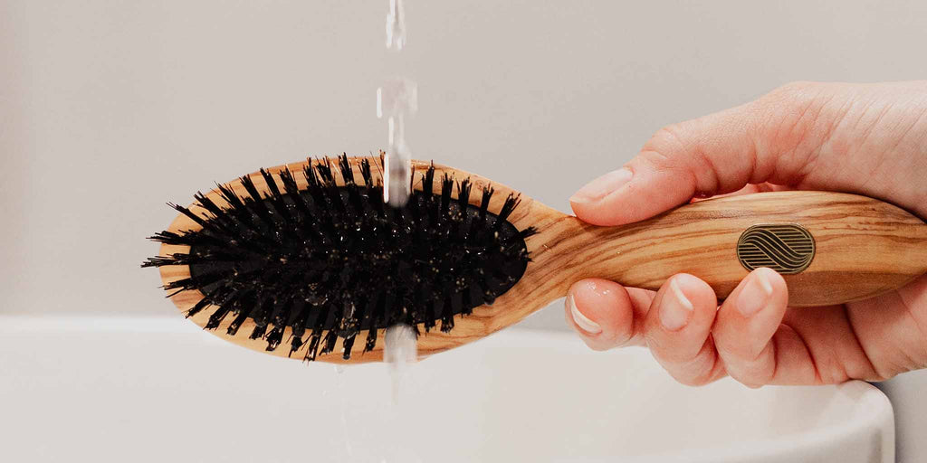 Clean your hairbrush with a cleaning brush